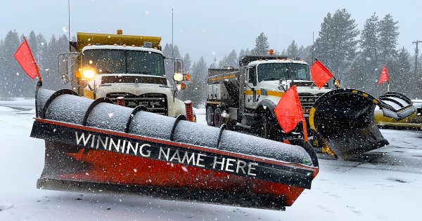 Two ITD snowplows. One has been digitally altered to say "Winning Name Here" on the front of the plow.