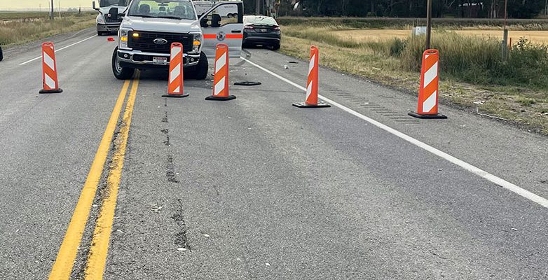 SH-33 with road blockades and a pickup truck following an accident