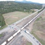 Aerial view of vehicles waiting for a train where Pleasant View Road intersects with SH-53.