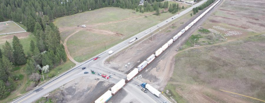 Aerial view of vehicles waiting for a train where Pleasant View Road intersects with SH-53.