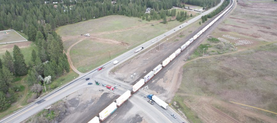 Aerial view of vehicles waiting for a train where Pleasant View Road intersects with SH-53.