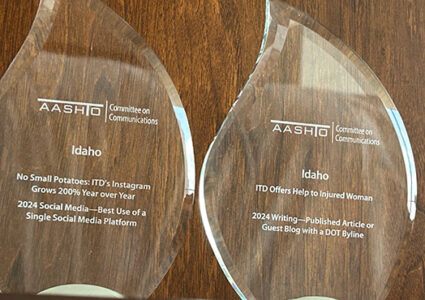Two clear glass trophies.