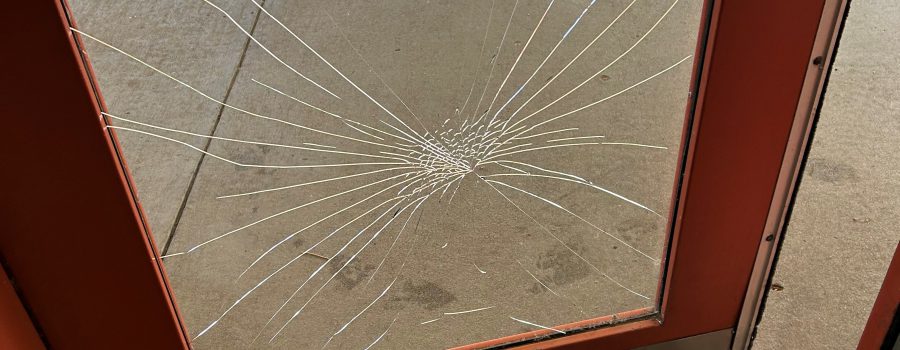 Broken door due to vandalism at Snake River Rest Area.