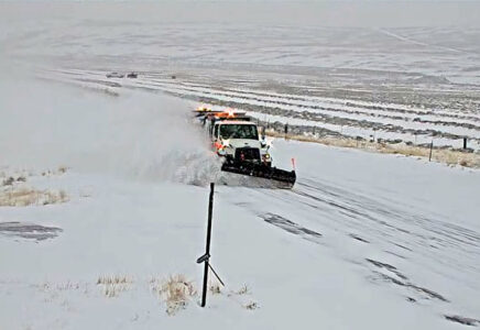 Snowplow on SH-28 plowing snow and creating a plume to the side.