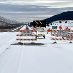 Snowy I-15 southbound roadway with road closure blockade signs and lights in place at Exit 184, Stoddard Creek.