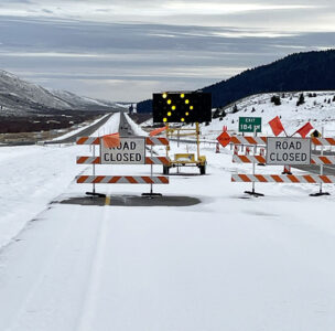 I-15 Exit 184 Stoddard Creek southbound snowy roadway with road closure blockade signs and lights in place for bridge closure