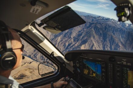 A pilot flying over mountains.
