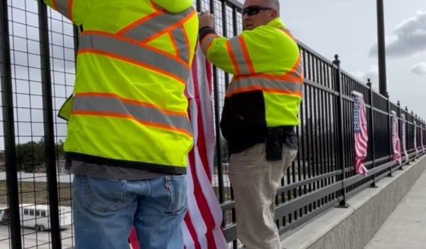 ITD hanging flags on the Cloverdale Overpass