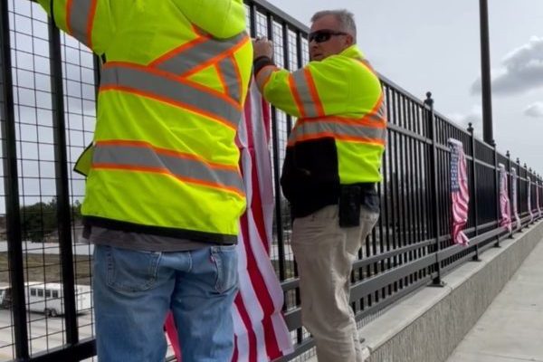 ITD hanging flags on the Cloverdale Overpass