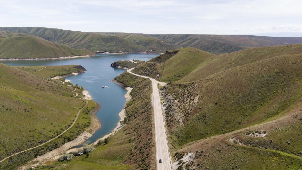 Cars driving on highway 21 along Lucky Peak Reservoir.