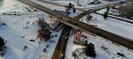 An aerial view of an overpass and a crane.