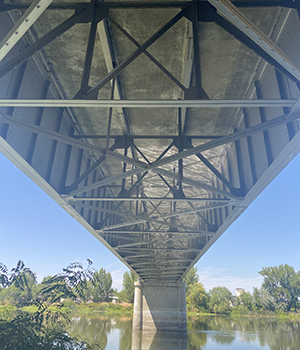 Looking at the underside of the bridge from the river.