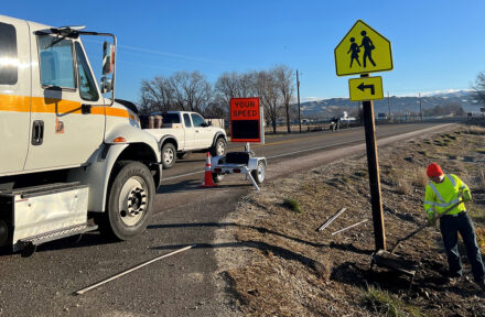 Operator installing a new school zone sign