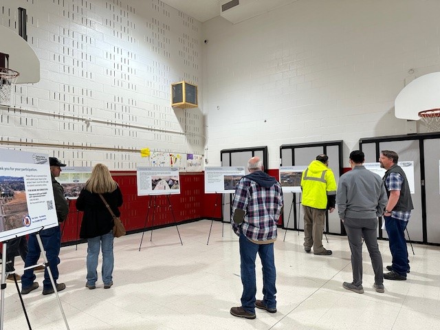Participants viewing display board at the March 2025 public open house.