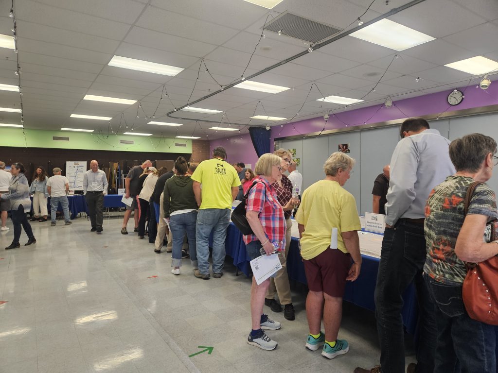 Community members review information at September 2025 public meeting in Emmett.