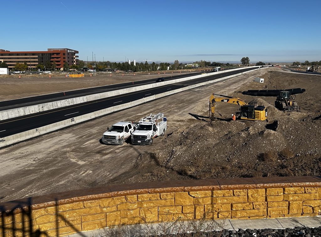 Photo of I-15 facing north from the Fort Hall Interchange with live traffic and work occurring.