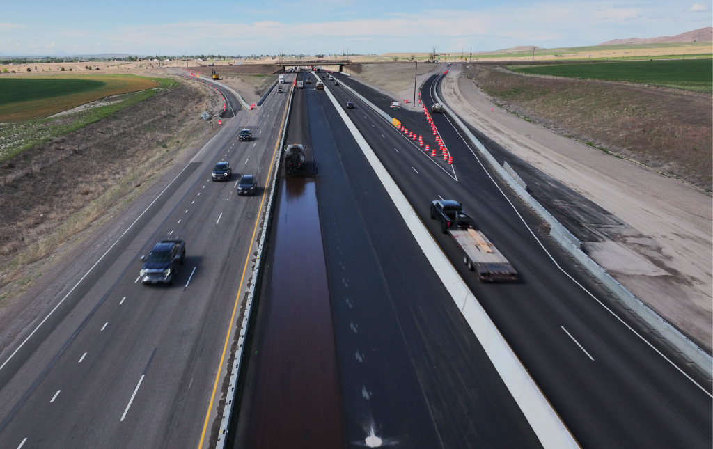 Drone shot of I-15 near the Fort Hall Interchange. Crews are paving the new lanes in the median of I-15 and live traffic is on the interstate.