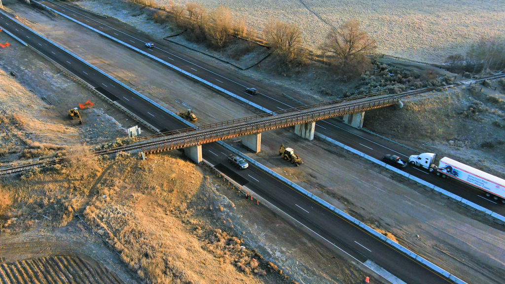 Aerial shot of the abandoned railroad bridge north of the Fort Hall Interchange and live traffic on I-15.