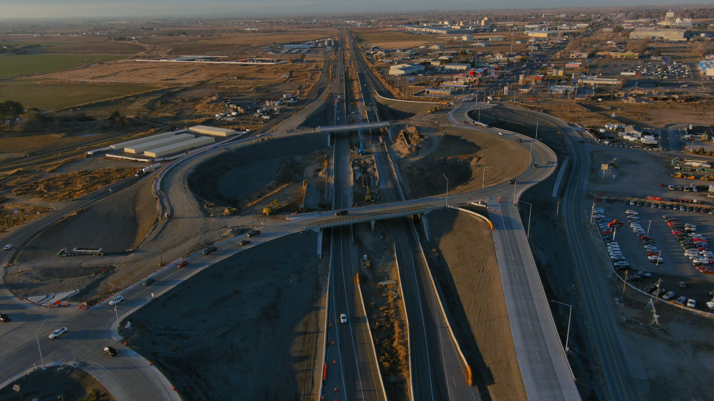 Drone photo of the I-84 South Jerome Interchange facing west with active construction and live traffic.