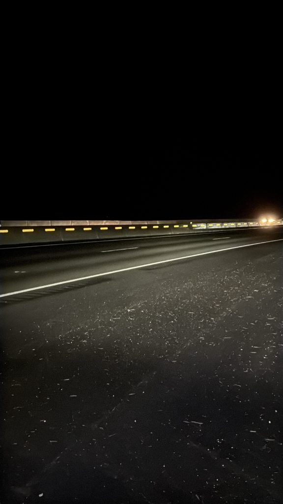 The roadway at night with upgraded reflective barriers making it much easier for drivers to see.