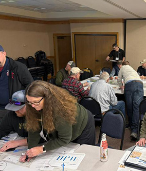 Attendees go over documents at the open house.