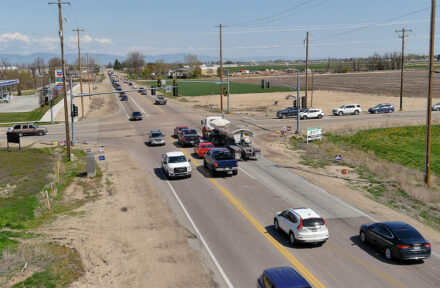 Cars pass through a busy intersection