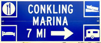 A blue sign that says "Conkling Marina 7 mi."