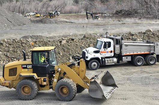 Picture of backhoe and a ITD truck.