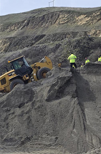 Picture of backhoe on a vertical slope.