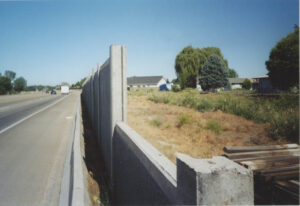 Noise barrier sound wall along a highway.