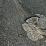Close up view of a gnarly pot hole on SH-3 near Clarkia.
