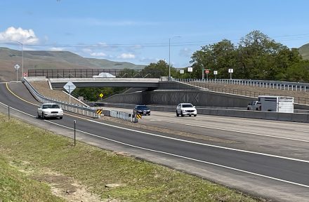 Picture of the US-95 Aht’Wy interchange looking across with traffic moving on either side.