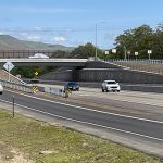 Picture of the US-95 Aht’Wy interchange looking across with traffic moving on either side.