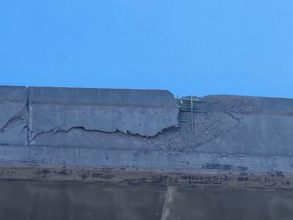 Highway overhead bridge close up of significant damage. 