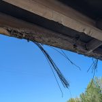 A damaged girder under a bridge