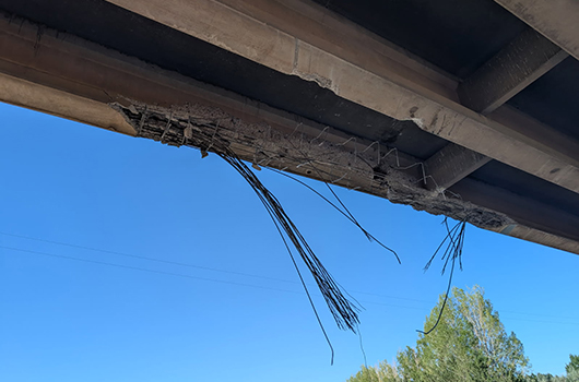 A damaged girder under a bridge