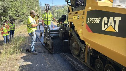 Crews operate the paver along a section of SH-3.