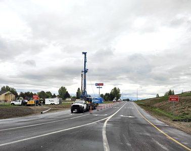US-20 Exit 332 University Boulevard Rexburg with heavy equipment and traffic control on ramp as large sign bridge posts are being installed