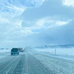 PR East Idaho Free Winter Driving classes roadside view of icy road with a pickup and snowplow in the distance