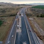 I-15 with construction being conducted on the new lanes between northbound and southbound lanes.