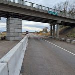 right hand lane of I-15 is open with a concrete divider protecting temporary pier supporting bridge.