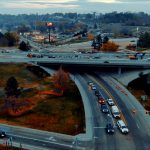 Aerial view of Interstate 84 at Franklin Road showing traffic moving beneath the overpass and active construction on the bridge above.