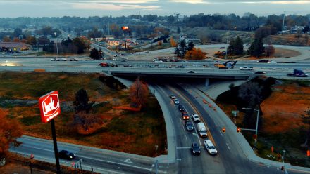Aerial view of Interstate 84 at Franklin Road showing traffic moving beneath the overpass and active construction on the bridge above.