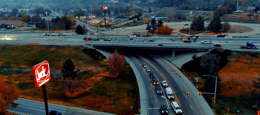 Aerial view of Interstate 84 at Franklin Road showing traffic moving beneath the overpass and active construction on the bridge above.