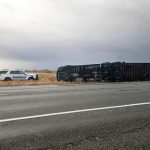 A semi on it's side over a roadway in Idaho as a result of a severe storm. Law enforcement and ITD vehicles in the scene as well.