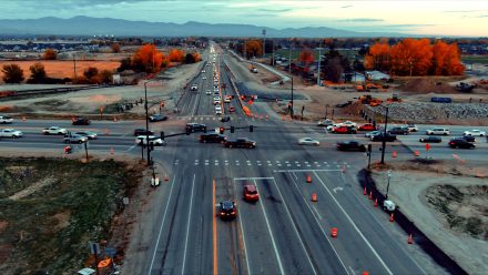 Aerial view of the State Highway 16 and State Highway 44 intersection showing heavy traffic, temporary signals, and active construction. Earthwork and construction equipment are visible around the intersection.