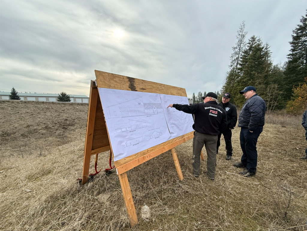 Fire district personnel show onlookers the design plans for the new fire station.