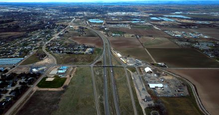 Aerial view of I-84 in Canyon County showing the SH-44 interchange area, surrounding farmland, nearby neighborhoods and the Boise River corridor where safety, capacity and interchange improvements are proposed between SH-44 and Centennial Way.