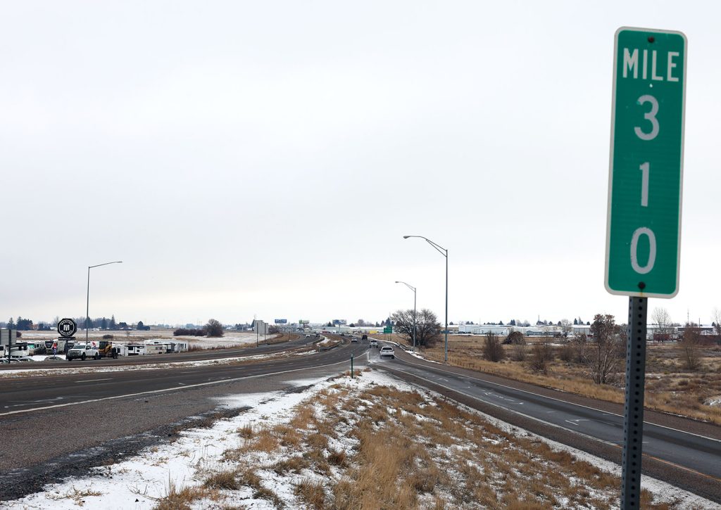 US-20 roadway and on ramp at Lewisville Exit 310 near Idaho Falls, showing green mile marker 310