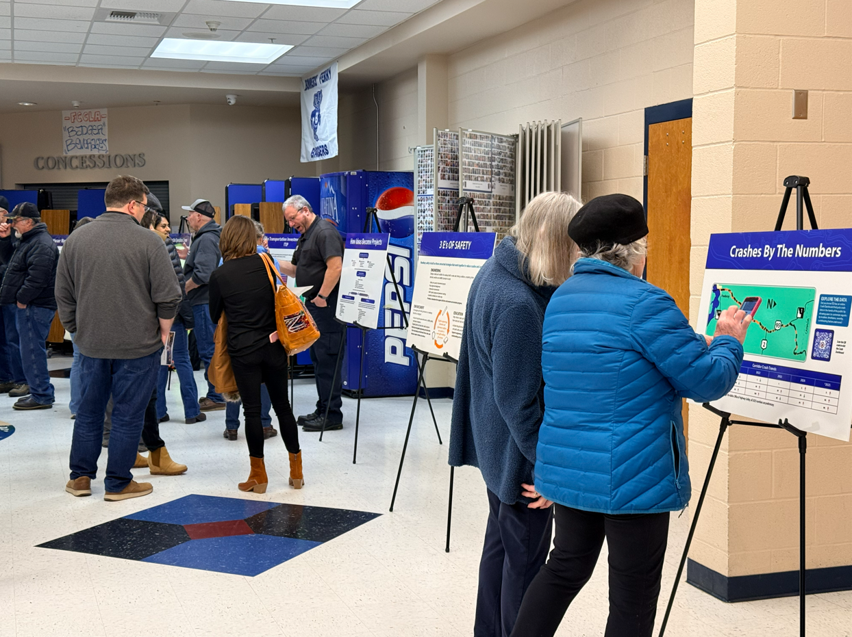 Attendees review display boards at the US-95 Corridor Safety Workshop